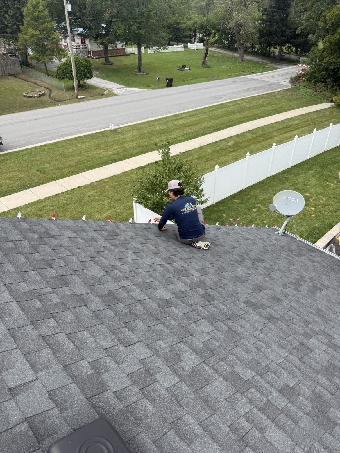 Son & Moon Services technician installing Christmas lights along a residential roofline