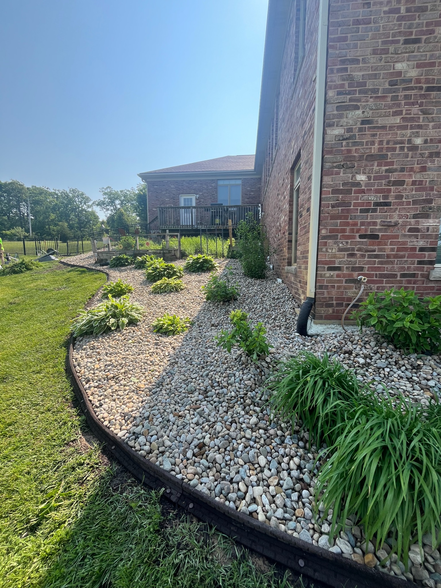 River rock landscape bed with plantings